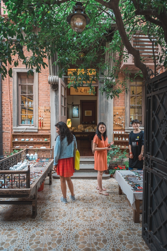 Three People in Traditional Chinese Courtyard
