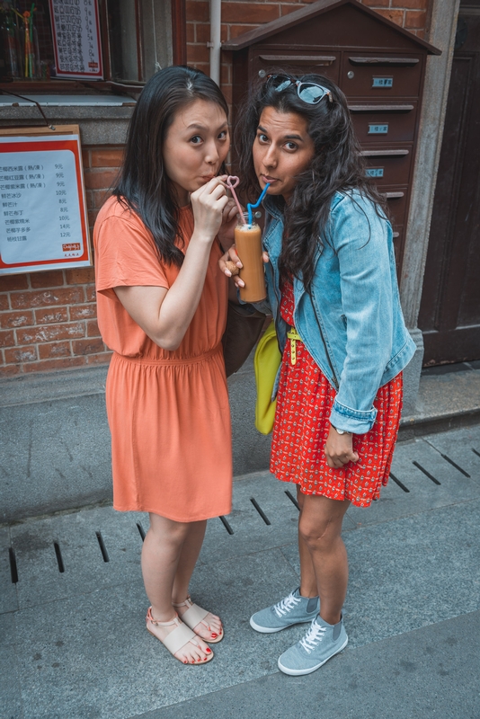 Two Women Sharing a Beverage Outdoors