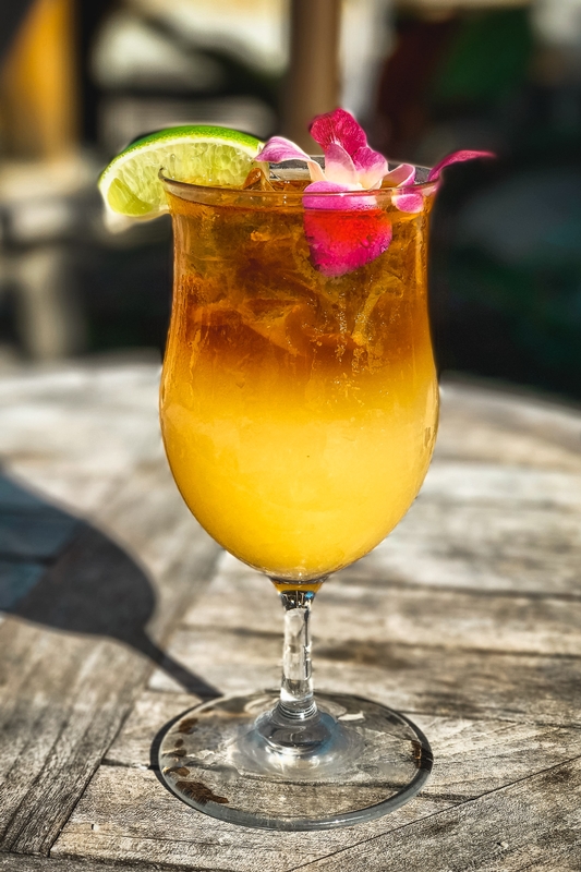 Golden Tropical Cocktail With Pink Flower