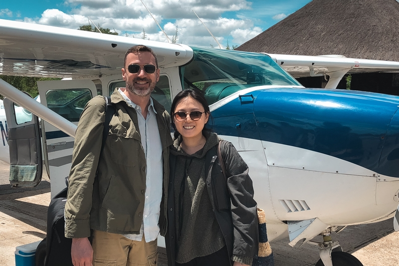 Travelers Posing By Small Aircraft