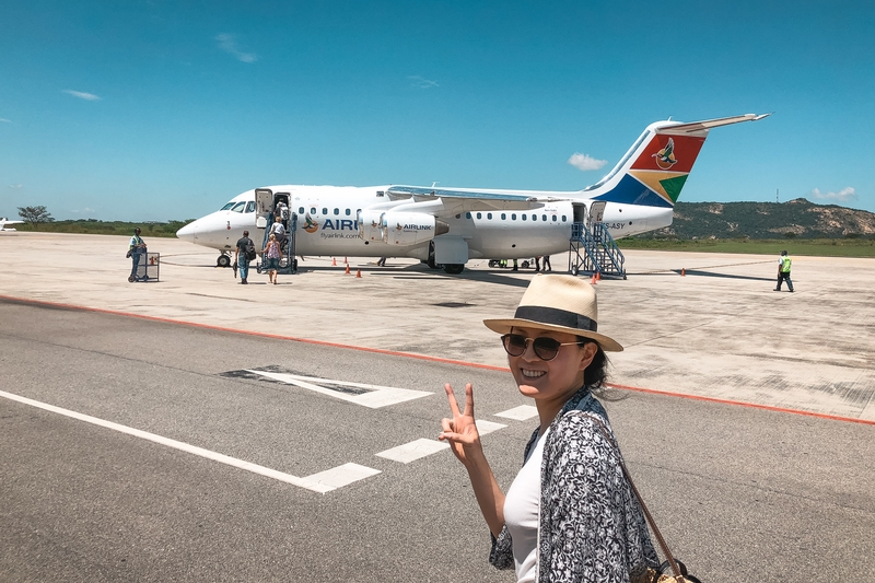Woman at Tarmac With Peace Sign