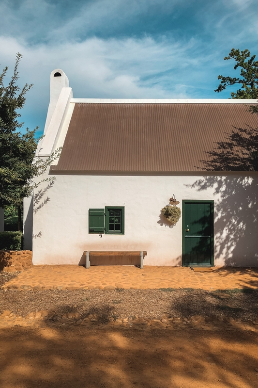 Cottage With Green Shutters and Shadows
