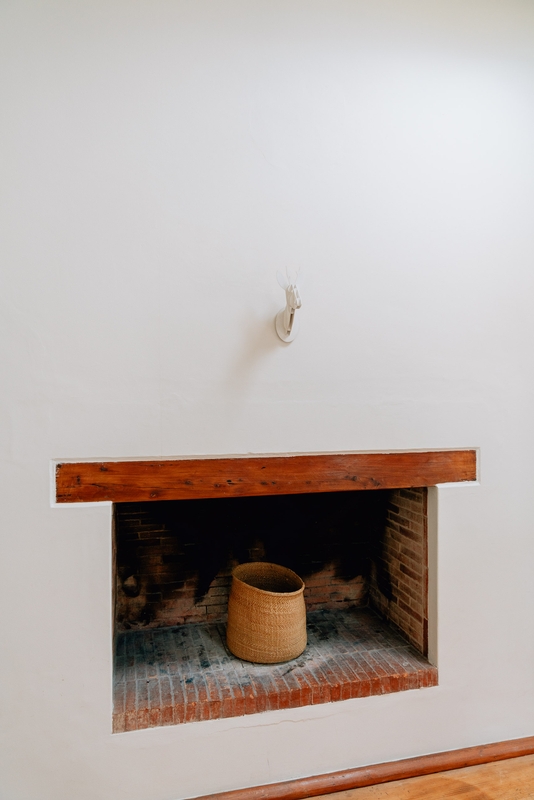 Rustic Brick Fireplace With Woven Basket