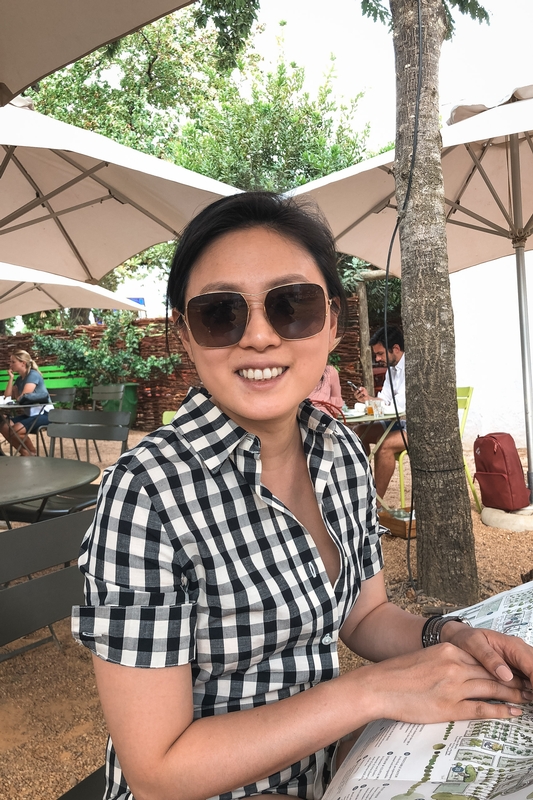 Woman Smiling at Tropical Patio Café