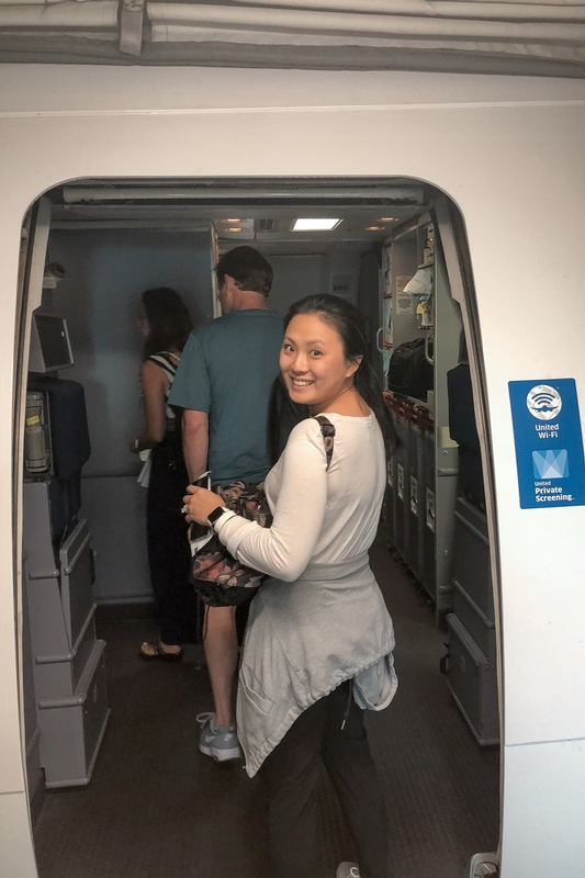 Passengers Smiling in Airplane Cabin