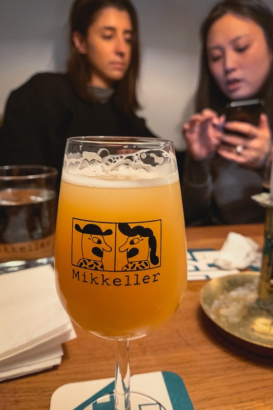 Mikkeller Ale Glass With Blurred Patrons