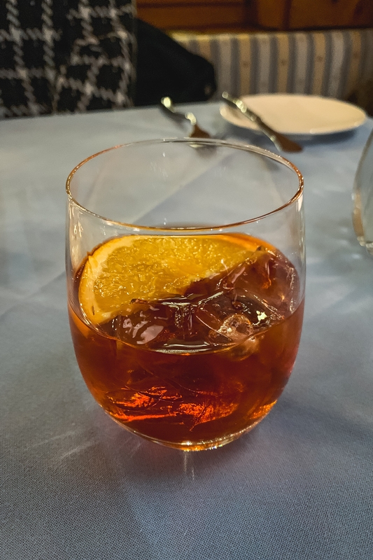 Amber Cocktail With Orange Garnish