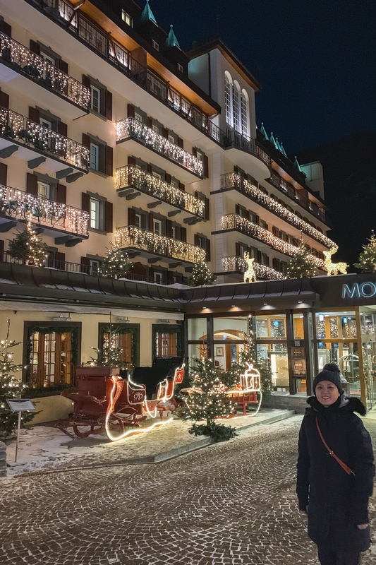 Woman Before Illuminated Holiday Hotel