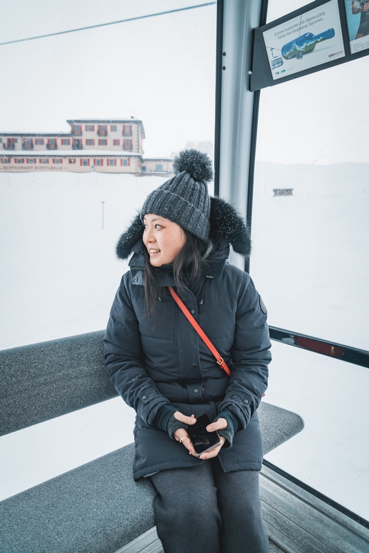 Woman on Cable Car With Alpine Views