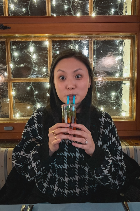 Woman Playing Harmonica by Holiday Window