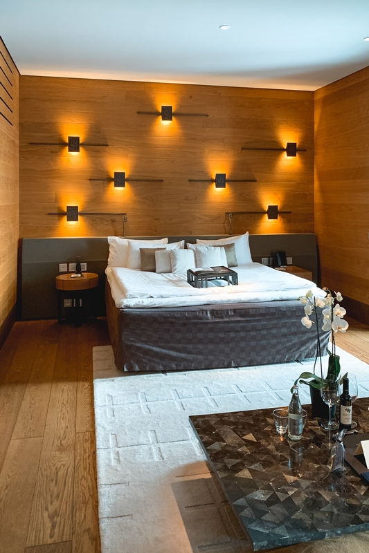 Warm Wood Paneling Bedroom With Uplighting