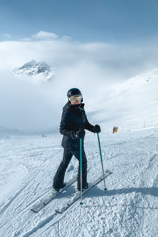 Skier On Alpine Slope With Mountain Peak