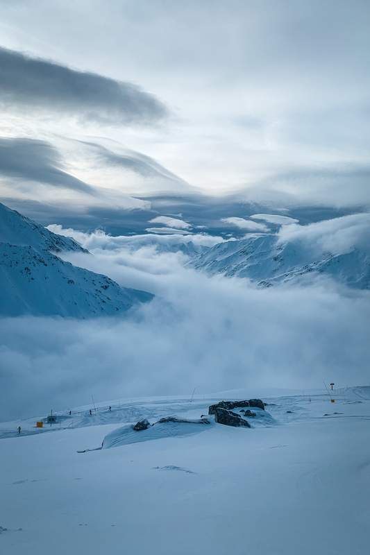 Snow-Covered Alpine Plateau With Distant Peaks