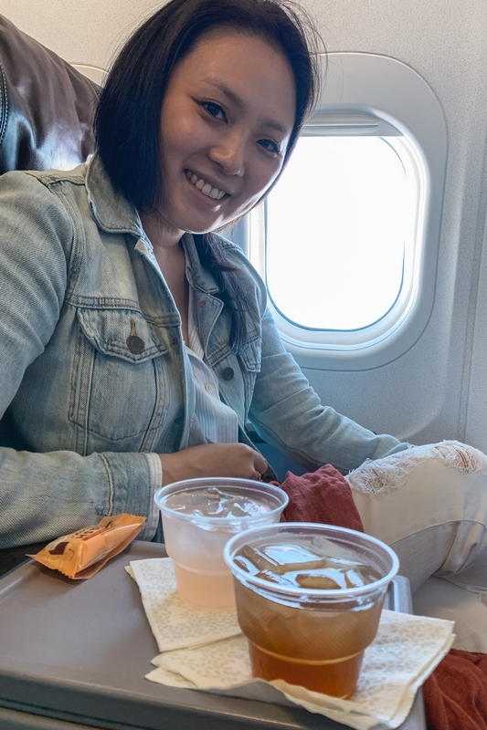Woman Enjoys Refreshments On Flight