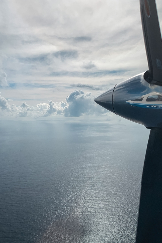 Small Plane Above Calm Ocean Waters