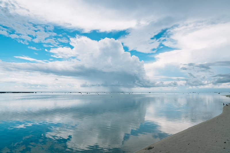 Glassy Waters Under Clouds