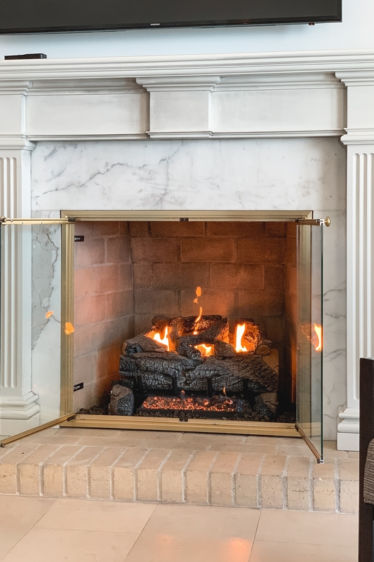 Elegant Marble Fireplace With Brass Doors