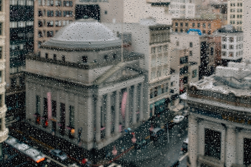 Rain-Streaked Window: Classical Dome and Skyscrapers