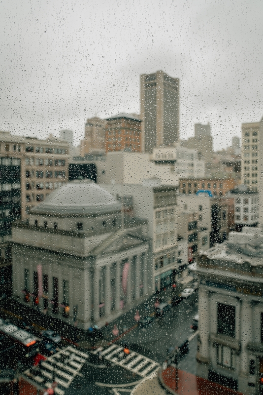 Rainy Urban Cityscape Through Window