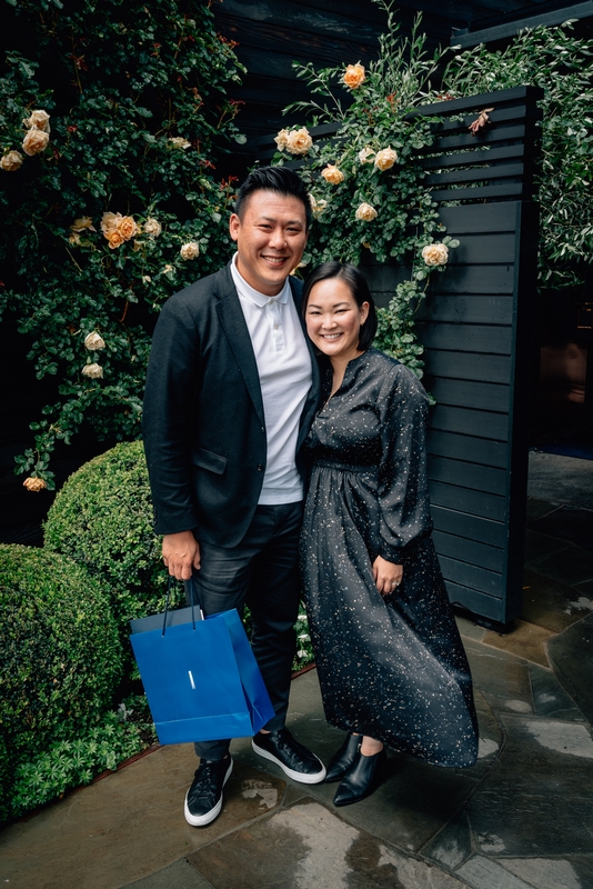 Couple Posing Before Floral Rose Wall