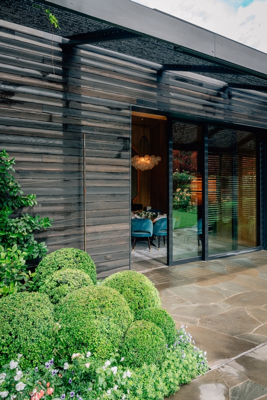 Modern Dark Wood Structure With Garden Patio