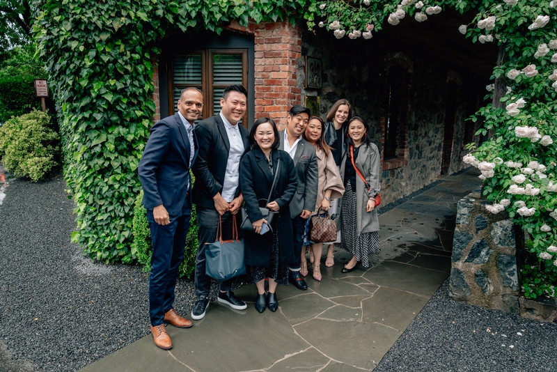 Professional Team in Ivy-Covered Passageway