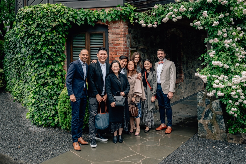 Professional Team Under Floral Archway