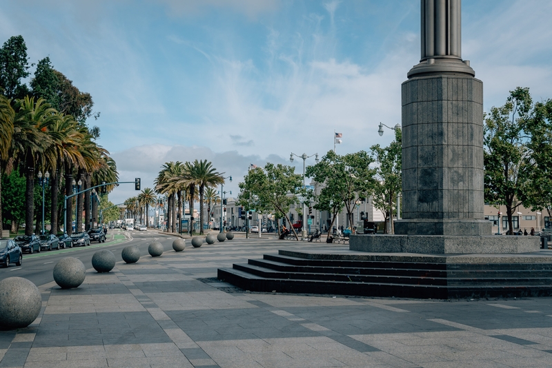 Palm-Lined Plaza With Cylindrical Monument