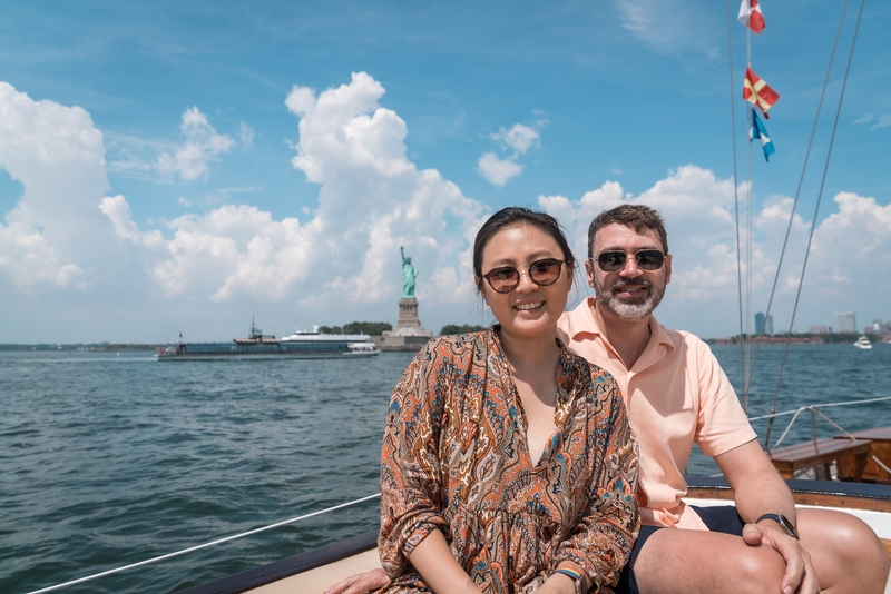 Couple on Sailboat Near Statue of Liberty