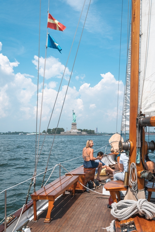 Sailing Vessel Passes Statue of Liberty