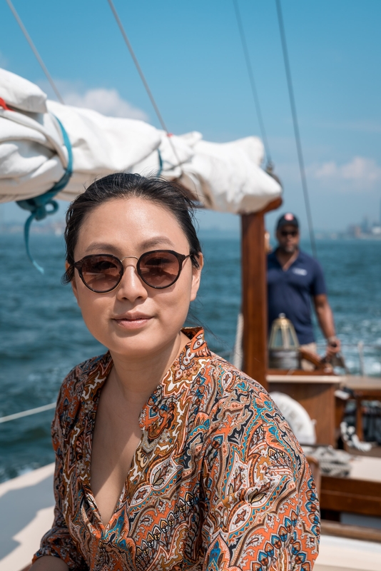Woman on Sailboat in Sunglasses