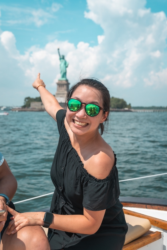 Woman Pointing at Statue of Liberty