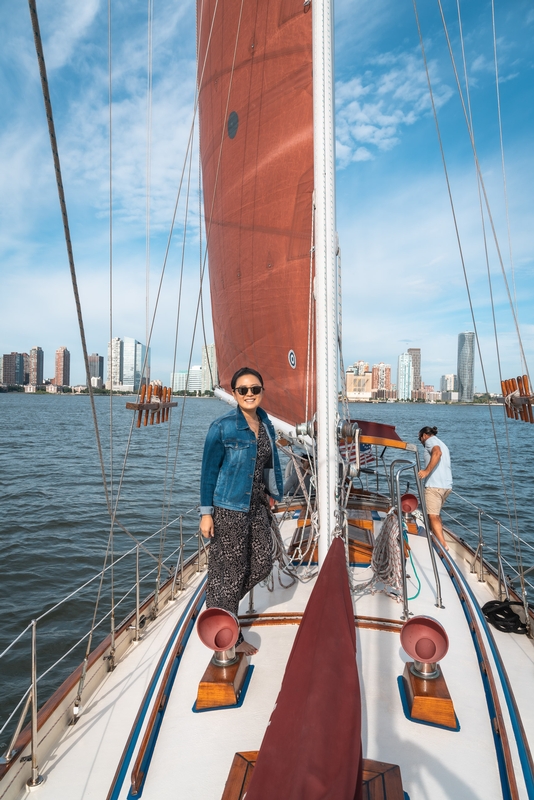 Woman Sailing Past Manhattan Skyline
