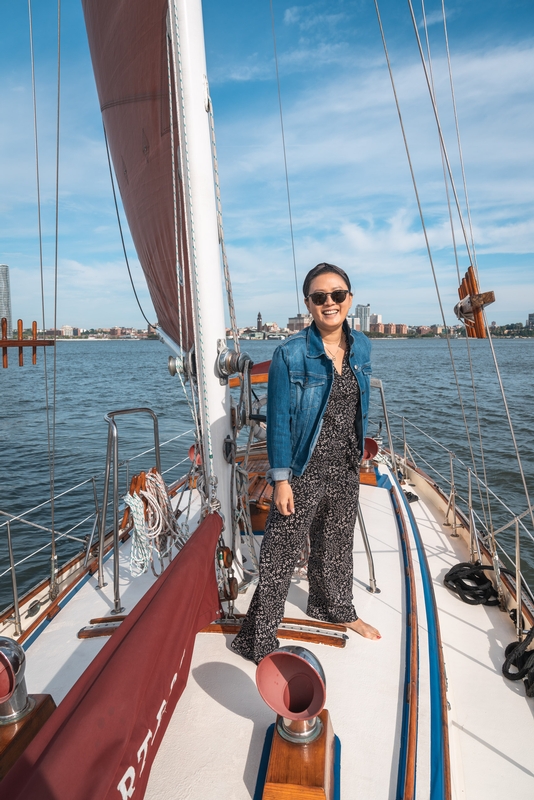 Woman Sailing With Manhattan Skyline