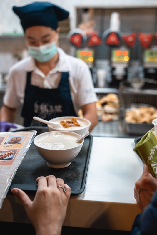 Masked Server Serving Soup In Taipei