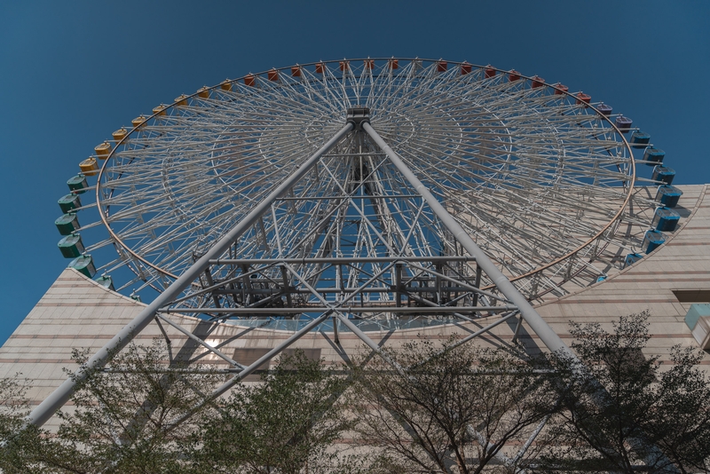 Towering Ferris Wheel Against Blue Sky