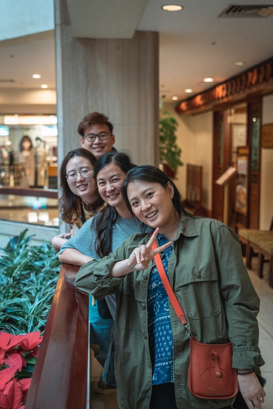 Young Friends Posing in Modern Mall Corridor