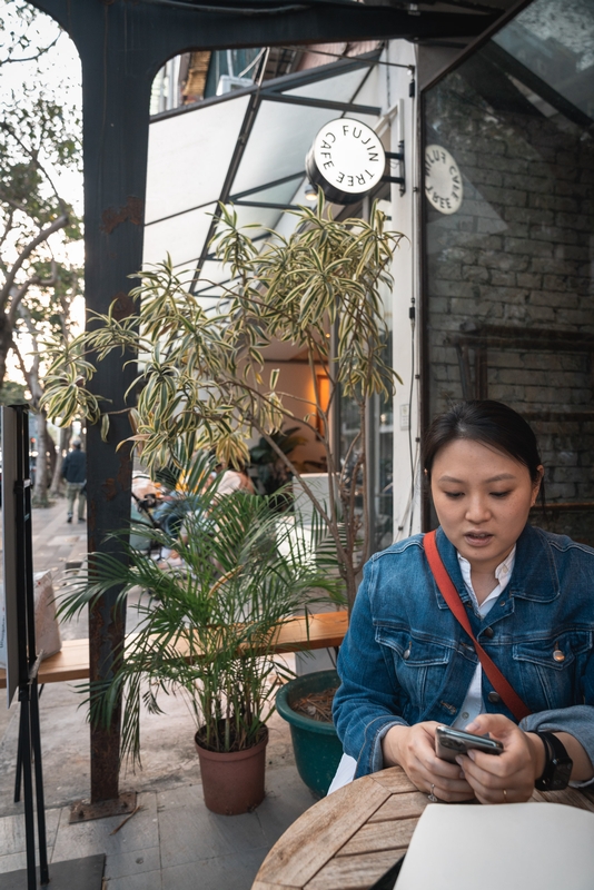 Woman at Outdoor Café With Plants