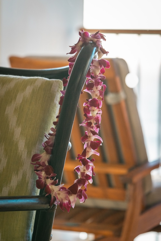 Burgundy Orchid Lei on Wooden Chair