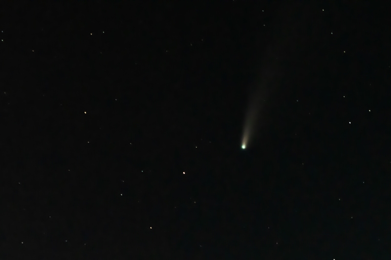 Comet Streaking Across Starry Night Sky