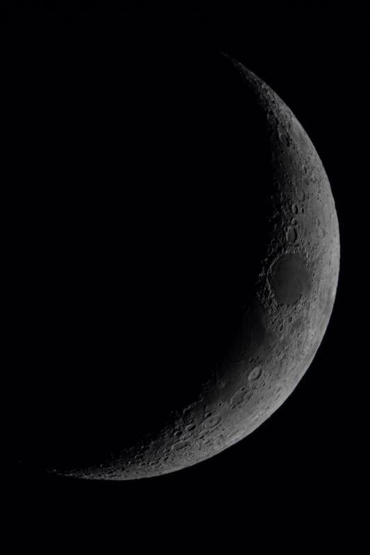 Detailed Lunar Crescent With Crater Features
