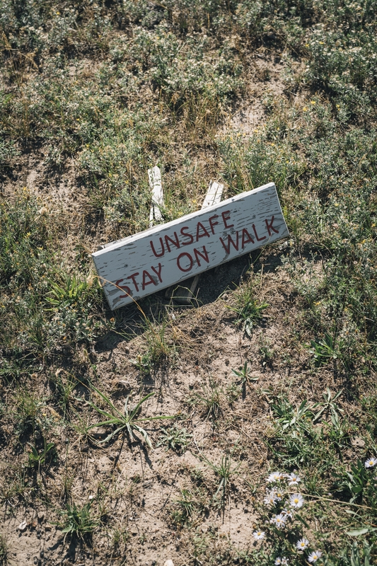 Weathered Safety Sign on Arid Ground