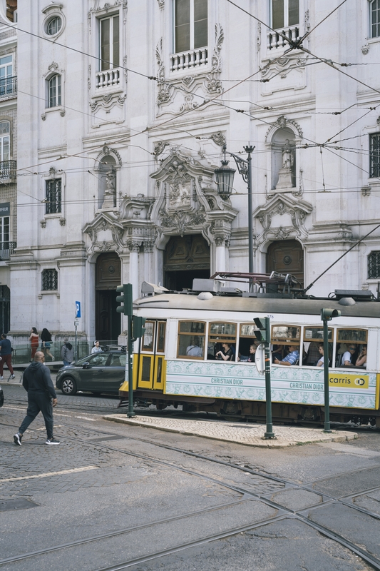 Historic Tram Passing Ornate Lisbon Facade