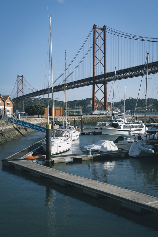 Sailboats Moored at Lisbon Harbor Bridge