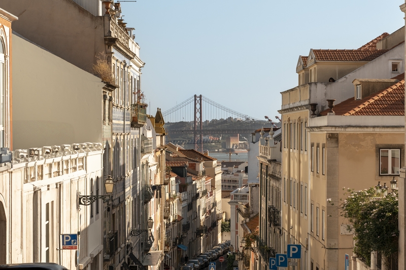 Lisbon Street View With 25 De Abril Bridge
