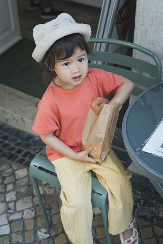 Lulu With Paper Bag On Green Chair